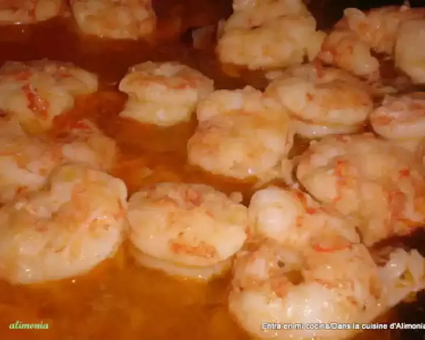 Gambas al pil pil burbujeando en aceite de oliva, listas para ser disfrutadas.