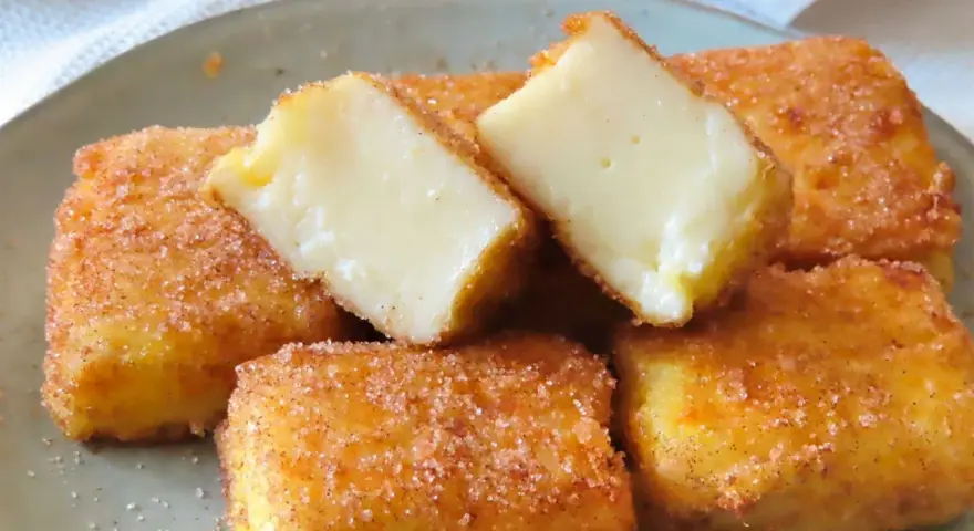 Deliciosa leche frita receta, crujiente por fuera y cremosa por dentro, espolvoreada con azúcar y canela.