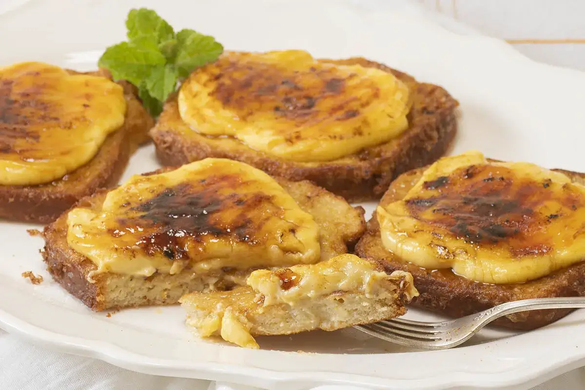 Torrijas caseras con crema y azúcar caramelizado, perfectas para tu receta.